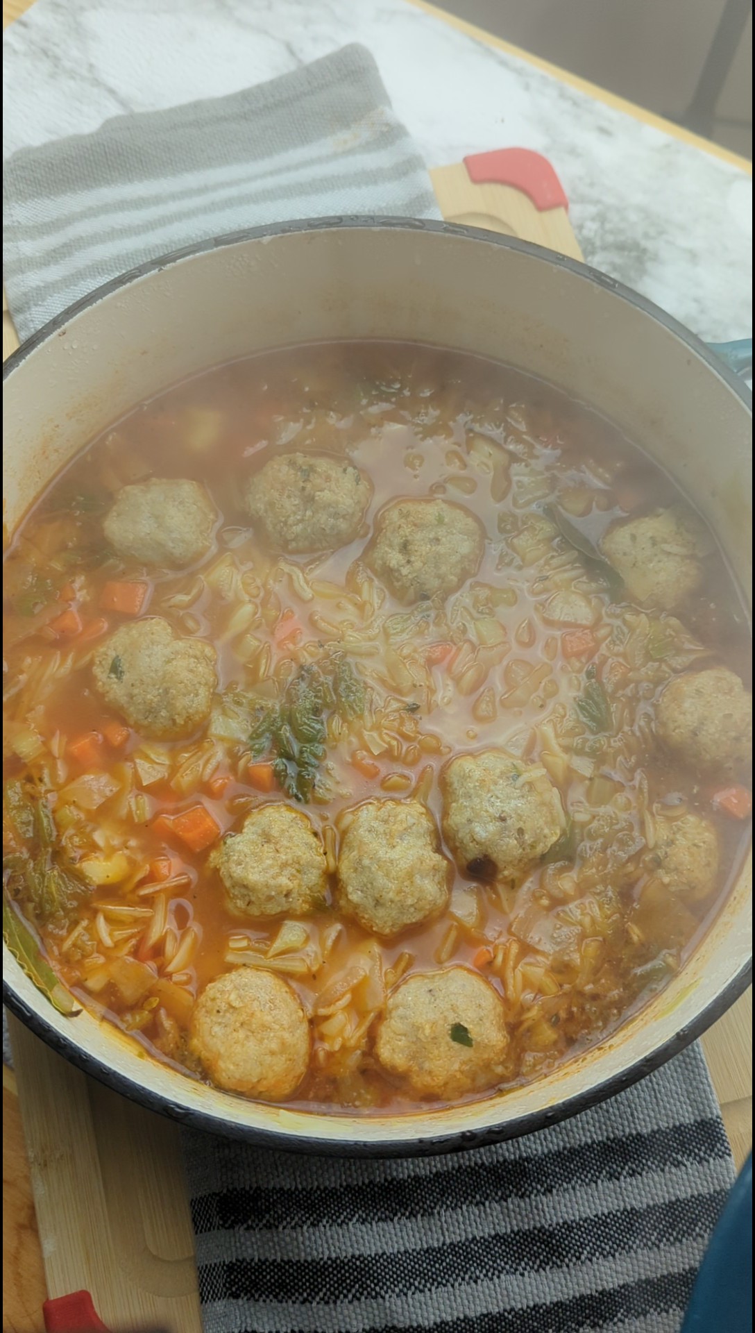 a hearty steaming bowl of cabbage soup with mini meatballs
