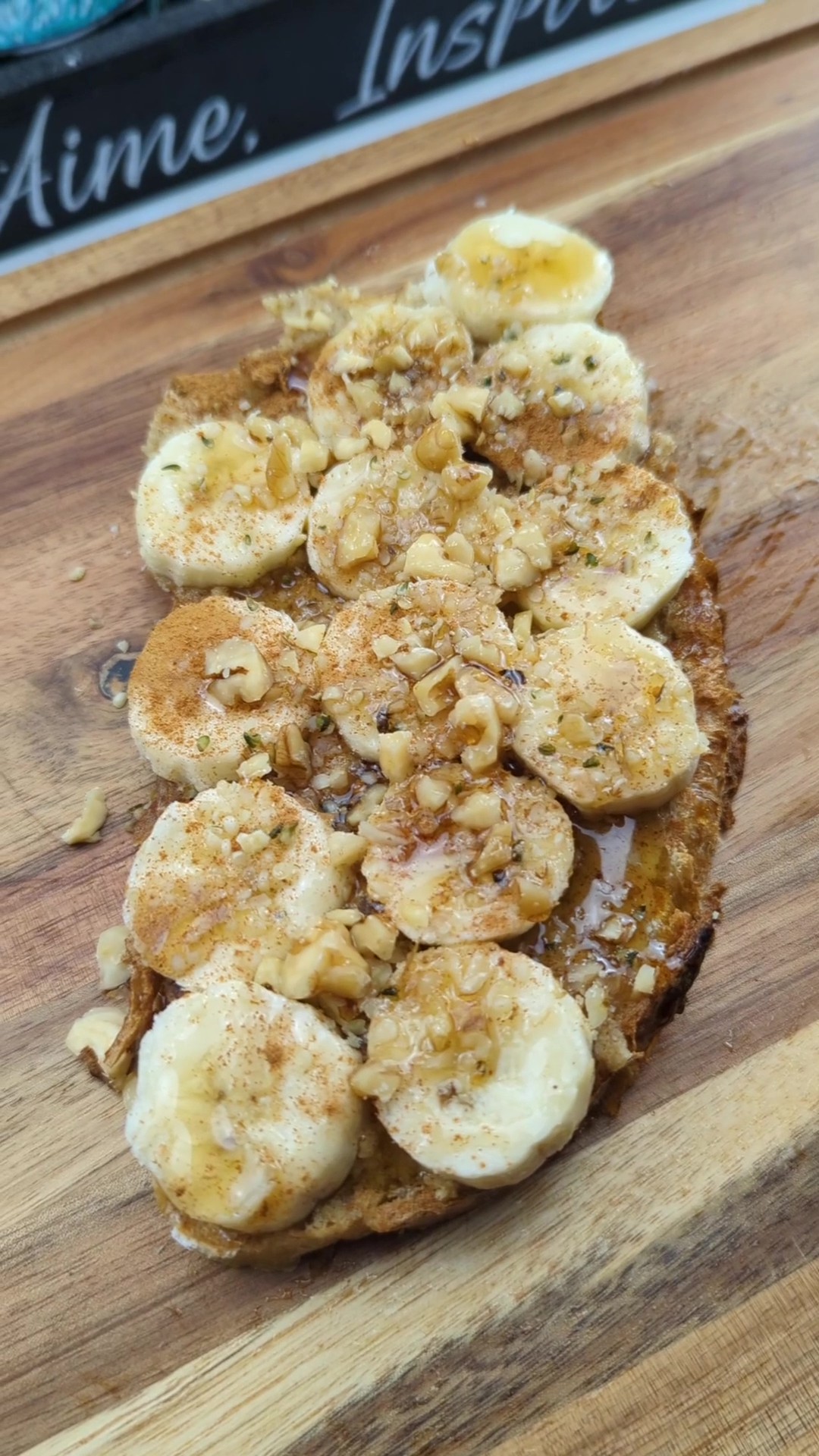 Slice of sourdough toast topped with homemade walnut butter and bananas
