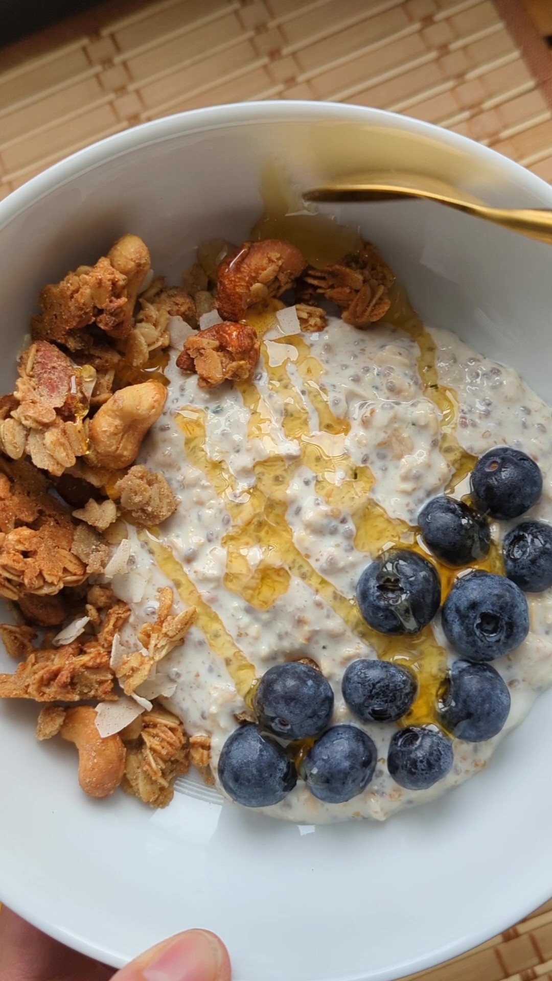 Hearty bowl of granola and oatmeal with fruit and honey